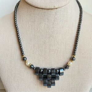 Hematite and faux pearls beaded necklace with pyramid front and goldtone accents